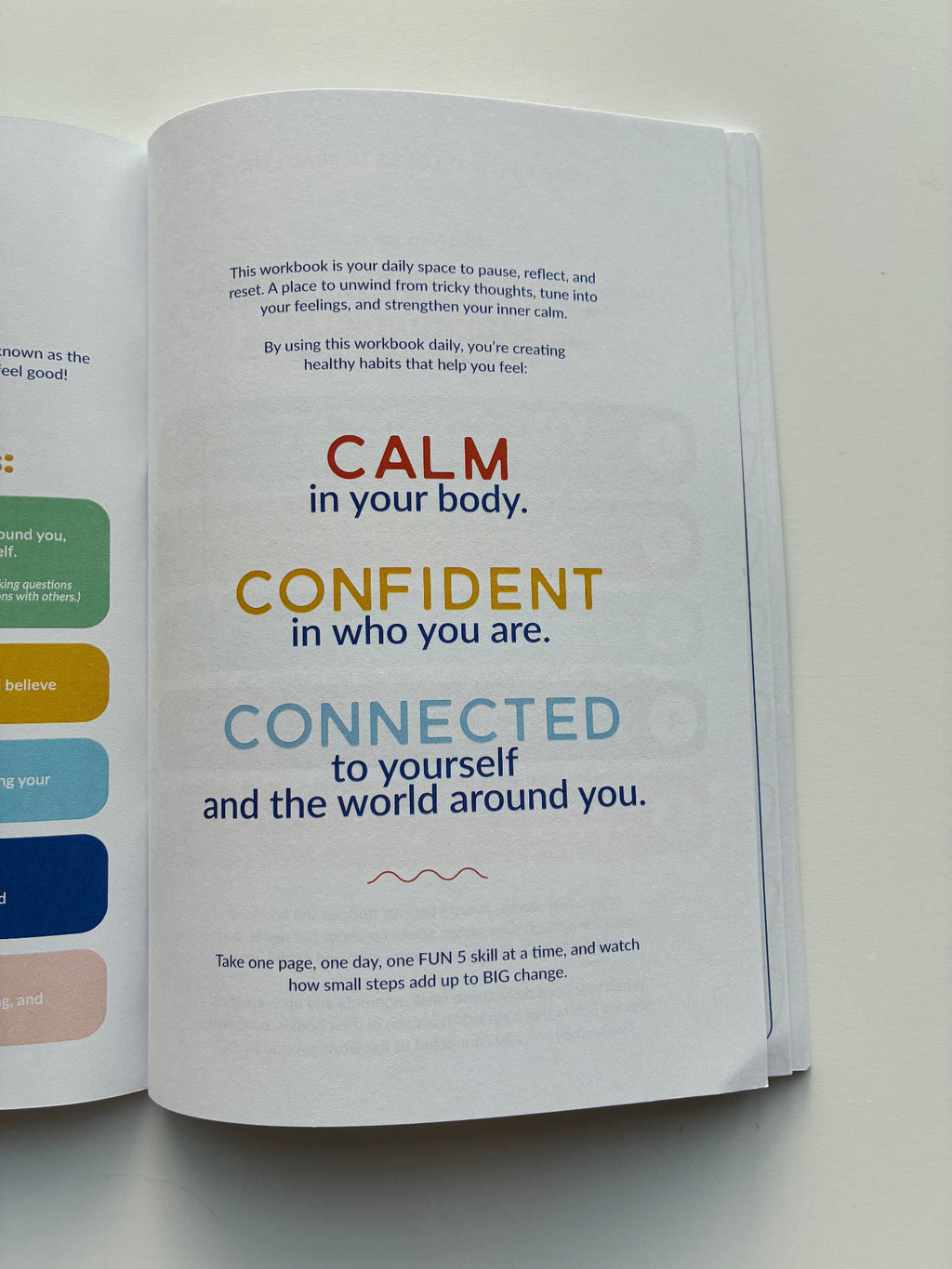 Open book with motivational text on a light background