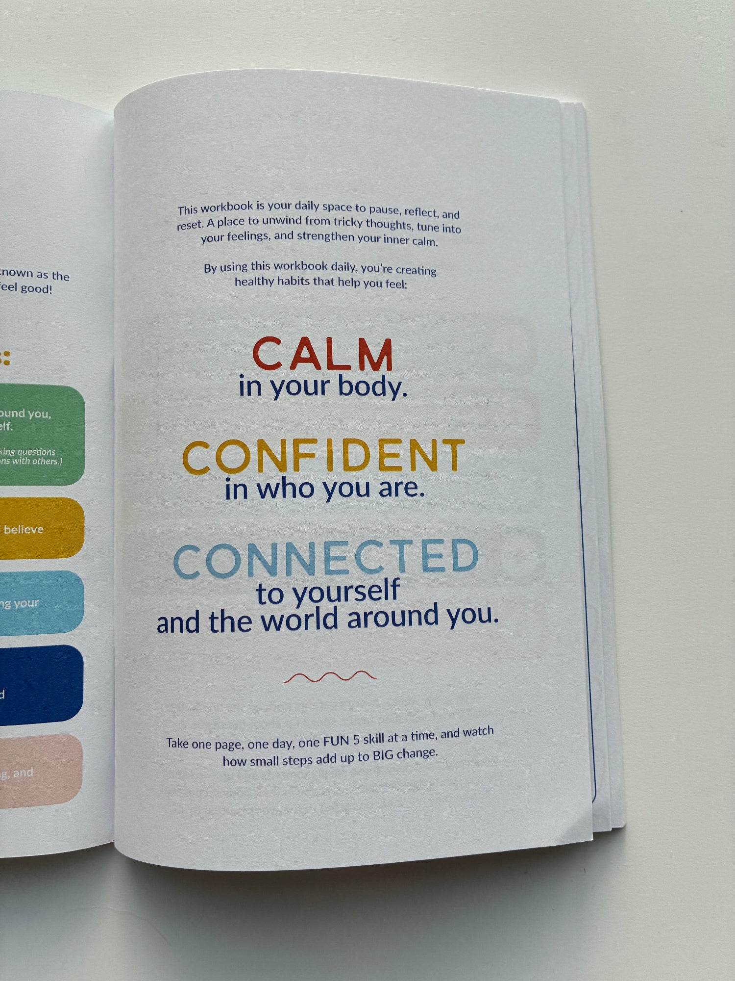 Open book with motivational text on a light background
