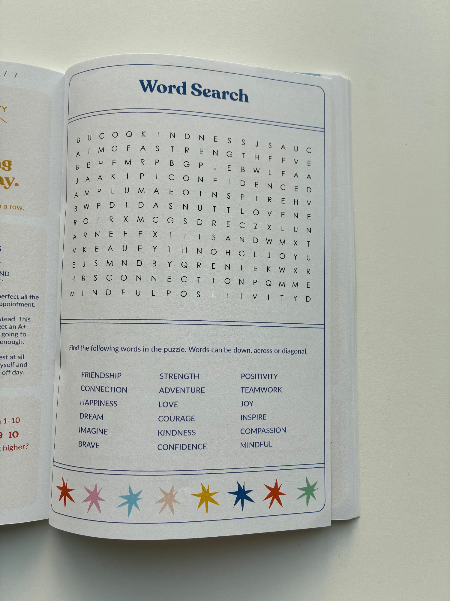 Open book with a word search puzzle and colored stars on a white background